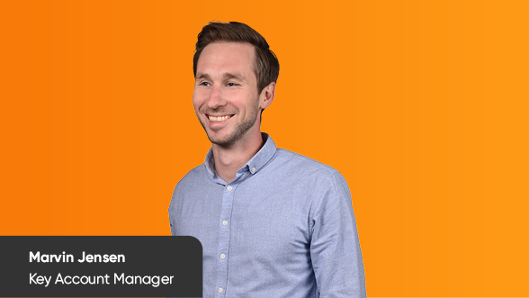 Portrait of Marvin Jensen on an orange background. Marvin is Key Account Manager at BSI Software.