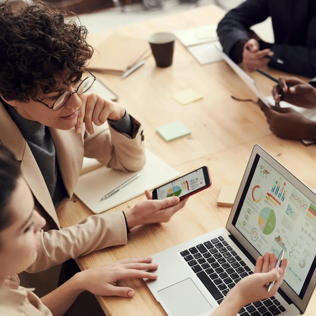 Team analyzes KPI dashboards and business data on laptop, tablet, and smartphone to define data-driven goals in customer relationship management and optimize business processes strategically. Source: fauxels@Pexels