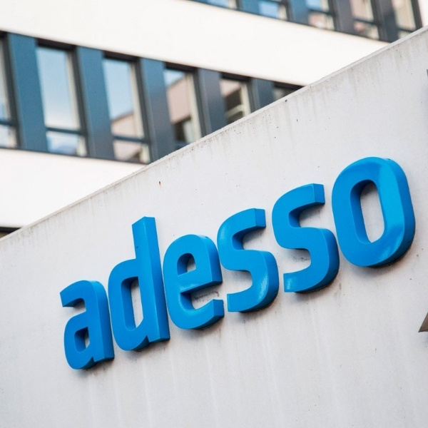 Building facade with large blue lettering “adesso” – partner of BSI Software.